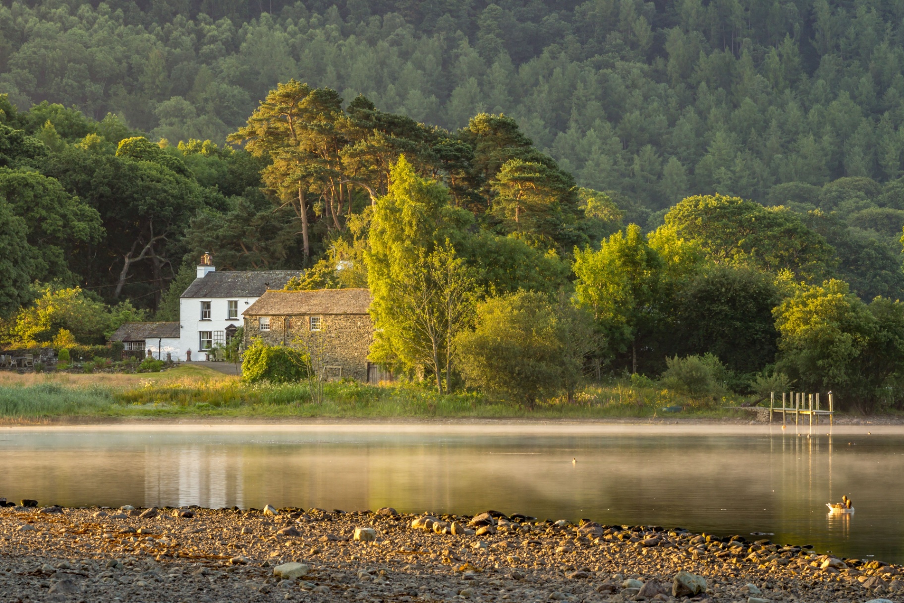 A peaceful UK lakeside cottage at golden hour